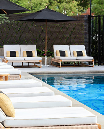 pool with lounge chairs and umbrellas